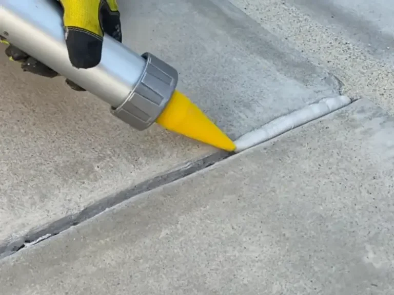Skilled team member repairing and sealing concrete cracks near Buffalo, NY.